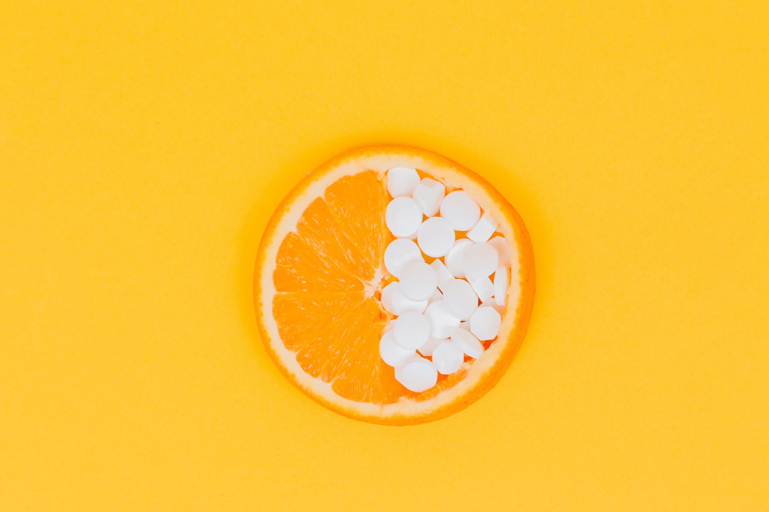 orange slice with folic acid supplements covering half