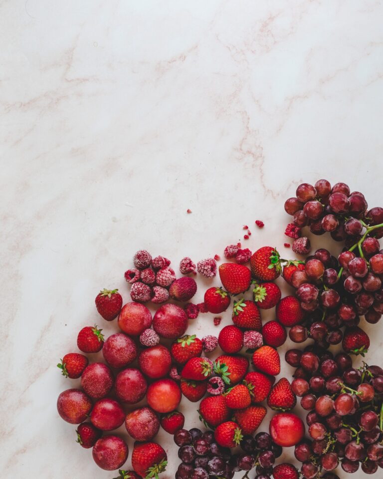 red grapes and strawberries scattered on counter