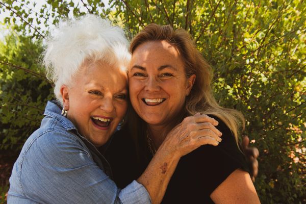 two post-menopausal women hugging