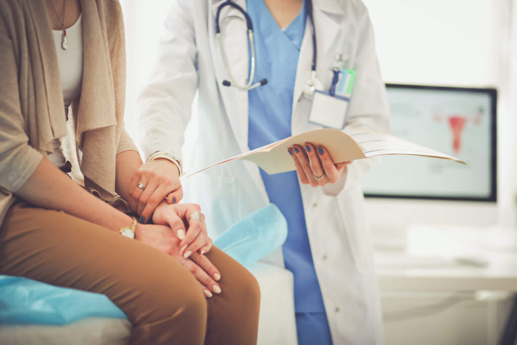 doctor holding woman's arm