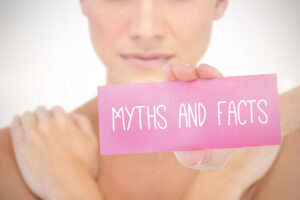 woman holding myth vs facts sign